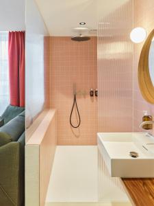 a bathroom with a tub and a sink and a shower at KORNHAUS Boutique Hotel in Murten +116 photos