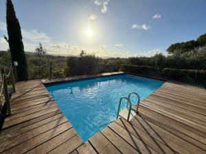 a large swimming pool on a wooden deck at B&B Il Pettirosso di Siena in Siena