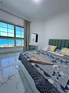 a bedroom with a bed with a quilt on it at جوليانا الغردقة juliana beach D410 in Hurghada
