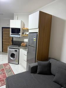 a kitchen with a couch and a kitchen with a microwave at جوليانا الغردقة juliana beach D410 in Hurghada +25 photos