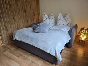 a bed with pillows on it in a bedroom at Waitzdorfer Landhaus Pieper in Hohnstein