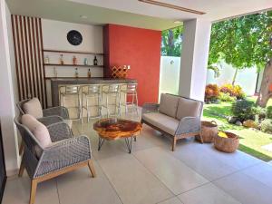 a patio with chairs and a table and a bar at Burgos Cuernavaca Pool Terrace & Garden in Temixco