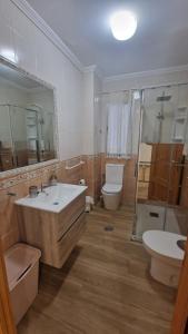 a bathroom with a sink and a toilet and a shower at Alojamiento Paco Cabrera 3C Reformado in Almuñécar +10 photos
