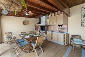 a kitchen and dining room with a table and chairs at Sunhouse El Chocito in Candelaria