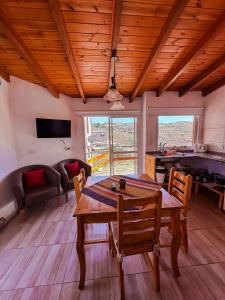 a living room with a wooden table and chairs at El Refugio in Córdoba