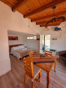 a bedroom with a bed and a table and chairs at El Refugio in Córdoba +16 photos