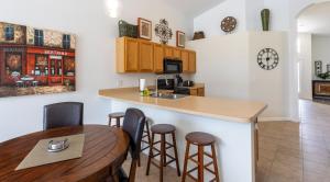 a kitchen with a bar and a table and chairs at AV340RD 4 Bedroom Charming Villa in Aviana home in Loughman +18 photos