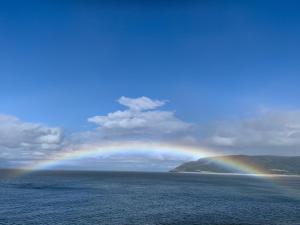 a rainbow over the ocean on a cloudy day at Locanda on the Weir in Porlock