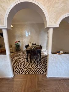 a dining room with a table in a room at Chez Aïcha in Safi +12 photos