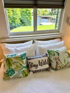 a group of pillows sitting on a bed with a window at Sunset Shores in Lake Clarke Shores