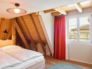 a bedroom with a bed and a window at KORNHAUS Boutique Hotel in Murten