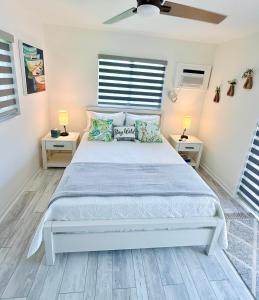 a bedroom with a large white bed with two night stands at Sunset Shores in Lake Clarke Shores +11 photos