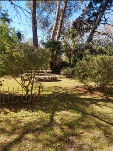 a park with a picnic table and some trees at Casa de Campo Brandsen - Quinta La Mandarina in Brandsen