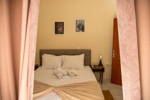 a bedroom with a bed with two pillows on it at Gk Suites-Constantin view , auto check-in 24h in Larisa +97 photos