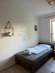 a bedroom with a bed and a wall with writing on the wall at myna in Thale +13 photos