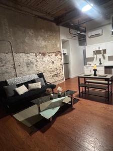 a living room with a couch and a table at The hancock loft in Philadelphia