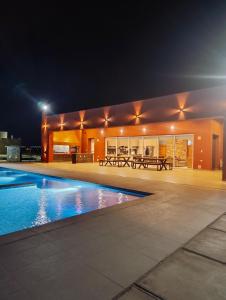 a house with a swimming pool at night at Casa RojoTeja in Pocito