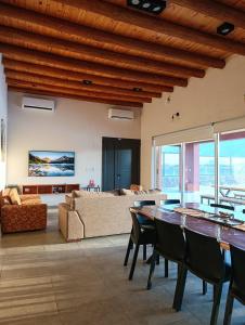 a living room with a table and a couch at Casa RojoTeja in Pocito