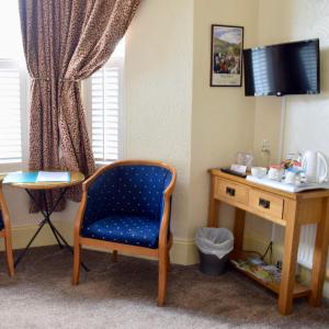 a room with a chair and a table and a television at Bewdley Hill House in Kidderminster +19 photos