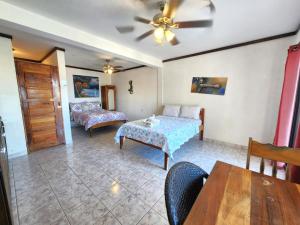 a living room with a bed and a table at Beach Side Condos Caye Caulker by CCVH in Caye Caulker +131 photos