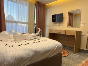 a hotel room with a bed with flowers on it at Pyramids Motel in Cairo