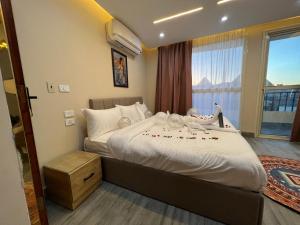 a bedroom with a large bed and a window at Pyramids Motel in Cairo +62 photos