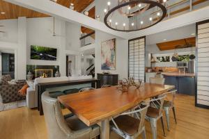 a dining room and living room with a table and chairs at Heaven and Earth - Luxury Accomodations, Breathtaking Mountain Views, Game Rooms + More! in Jasper