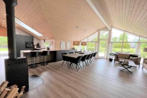 a dining room and kitchen with a table and chairs at M184-Vaeggerlose-Kaninstien-41 in Bøtø By
