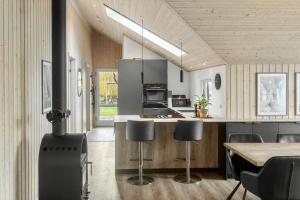 a kitchen with a stove and a table and chairs at M184-Vaeggerlose-Kaninstien-41 in Bøtø By +20 photos