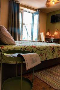 a bedroom with a bed with a book on it at Chambre Henriette in Incourt