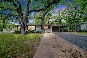 a house with a tree and a driveway at Backyard Oasis w/Pool, Hot-Tub, Grill & Fire Pit! in Fredericksburg