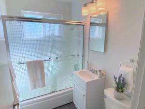 a bathroom with a shower and a toilet and a sink at Downtown-King Bed-Top Floor-Parking-Wi-Fi in Walnut Creek +27 photos