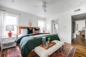 a bedroom with a large bed with a green bedspread at Backyard Oasis w/Pool, Hot-Tub, Grill & Fire Pit! in Fredericksburg +26 photos