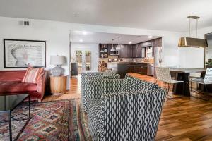 a living room with couches and a dining room at Backyard Oasis w/Pool, Hot-Tub, Grill & Fire Pit! in Fredericksburg