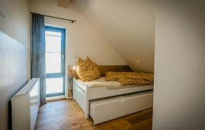 a bedroom with a bed and a window at Modern Chalet With Sauna Near Thuringian Forest in Zella-Mehlis