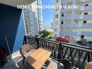a table and chairs on a balcony with a building at Hotel Concept Best Family Rezidance Home in Konaklı