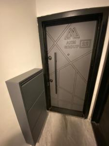 a glass elevator door with a sign on it at Hotel Concept Best Family Rezidance Home in Konaklı +9 photos