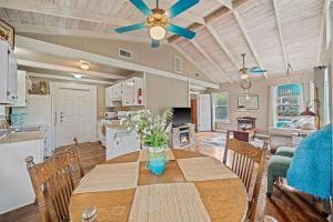 a dining room with a table and a ceiling fan at Ava and Weston Combo House in Fredericksburg
