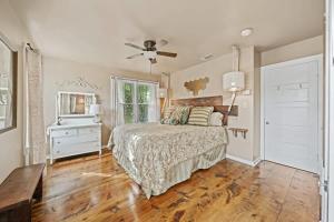 a bedroom with a bed and a ceiling fan at Ava and Weston Combo House in Fredericksburg