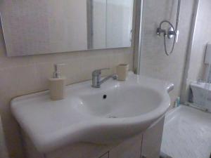 a white sink in a bathroom with a mirror at MY HOUSE to Cinque terre in La Spezia