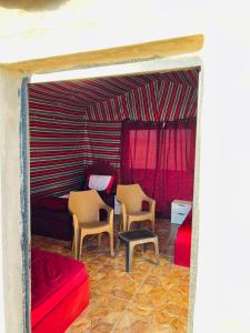 a living room with two chairs and a couch at Dana Sunset Eco Camp in Dana