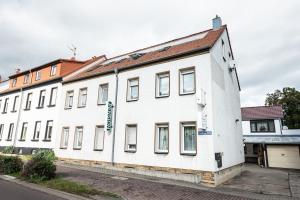 a large white building on a street at Pension Greiser in Leipzig