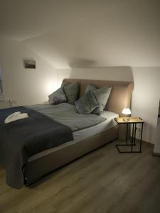a bedroom with a bed and a side table at Ferienwohnung Am Sonnenbrink in Goslar