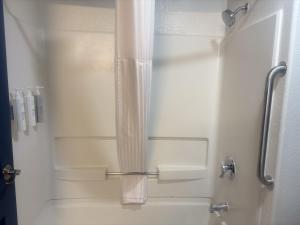 a shower with a glass door in a bathroom at Spark by Hilton Lakewood Denver Southwest in Lakewood