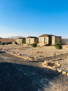 a row of houses in the middle of a desert at Dana Sunset Eco Camp in Dana