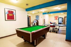 une salle de billard avec un billard et une table dans l'établissement Topaz Hotel, à San Pawl il-Baħar