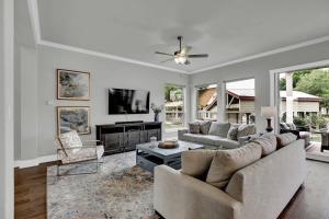 a living room with a couch and a tv at Stunning Luxury Home on Lake LBJ! in Horseshoe Bay