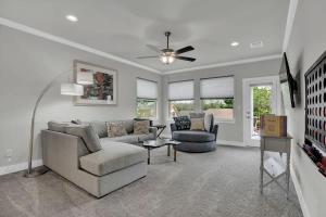 a living room with a couch and chairs and a ceiling fan at Stunning Luxury Home on Lake LBJ! in Horseshoe Bay