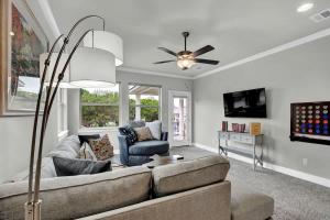 a living room with a couch and a ceiling fan at Stunning Luxury Home on Lake LBJ! in Horseshoe Bay