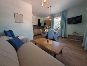 a living room with a couch and a table at Apartmány penzion Jasmín in Liberec